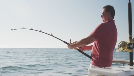 Side-view-of-a-Caucasian-man-fishing-on-boat