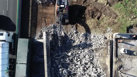 aerial drone shot of piles of concrete after destruction of highway bridge