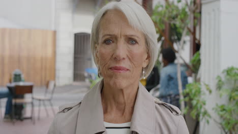 portrait-of-elderly-business-woman-looking-serious-at-camera-sophisticated-middle-aged-female-in-urban-outdoors-background