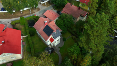 drone shot around a modern solar powered house in a nordic neighborhood