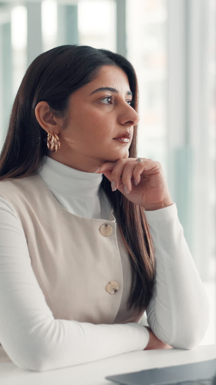 Thoughtful Young Businesswoman Contemplating Ideas in a Modern Office