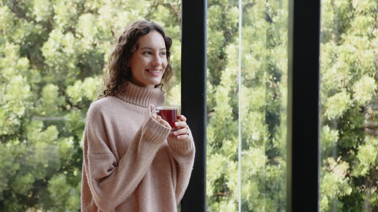 Smiling woman holding cup of tea, enjoying relaxation at home retreat