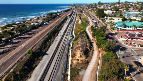 slow motion shot over coast highway 101 and the train tracks along the cardiff-by-the sea coast in encinitas, california