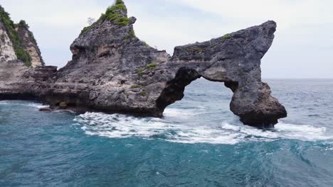 natural stone arch bridge and rock formation of limestone sea mount formed by coastal erosion and waves