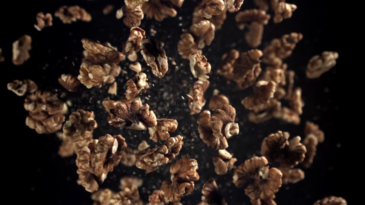 Walnuts Falling in Slow Motion Against a Black Background