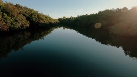 drone flying over a river in the countryside