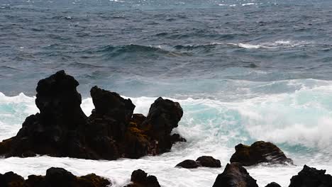 a huge wave covers the lava fingers on the north coast of maui, hawaii.
