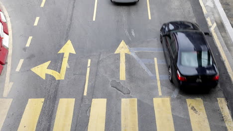 top view of pavement crossing walk on the main road with moderate traffic in the city street of kuala lumpur