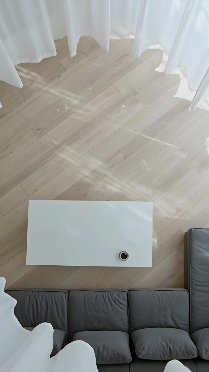 Vertical video: Panning overhead camera revealing white coffee table in living room, light shifting