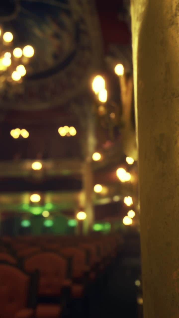 Elegant theater interior features ornate design and dim lighting