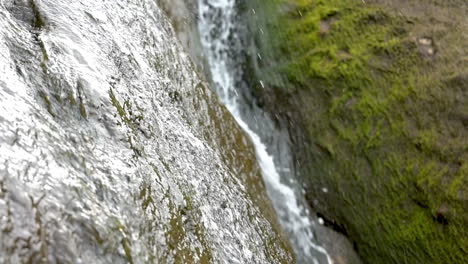 zoom in on waterfall running down sandstone rocks