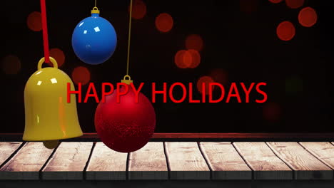 animation of red happy holidays text with colorful baubles and bell over lens flares and table