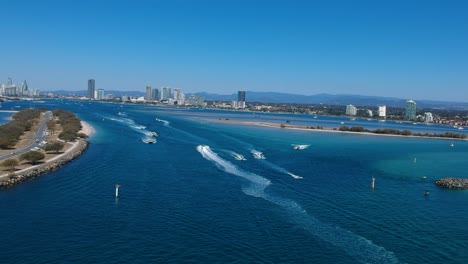 aerial view of a busy day on popular waterway with a city skyline in the distance