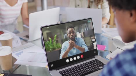 Animation-of-biracial-man-having-video-call-on-laptop