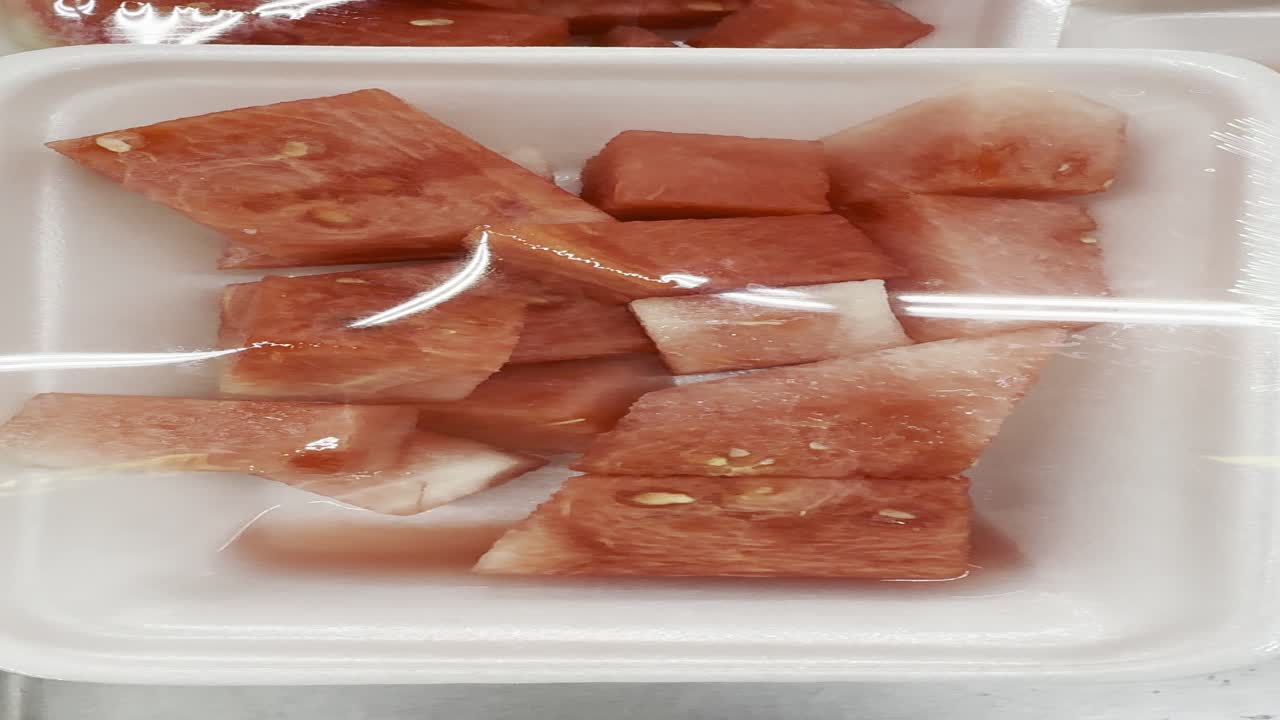 Fresh Cut Watermelon Pieces in a Plastic-Wrapped Tray