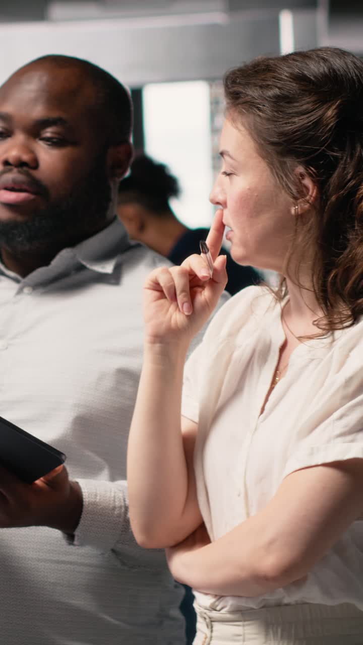 Vertical Video Multiethnic engineers uniting forces for residential project layout