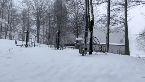 outside fitness and gym devices covered in fresh white snow in the nature of górowo iławeckie on a cloudy day