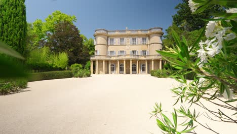 slow revealing shot from behind foliage of the luxury chateau de castille, provence