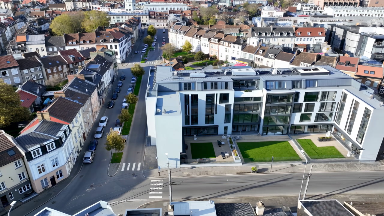 Aerial View Modern Office Courtyard And Street, Drone Capture Showcases Glass Facade, Rooftop Green Lawn, Tram