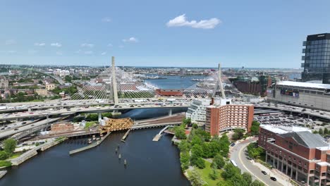 drone shot of the zakim bridge in boston on a sunny day with cars driving over it