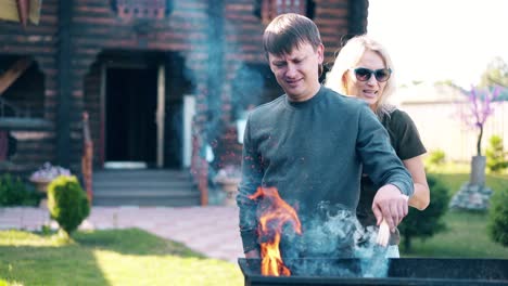 travelling young guy with girl standing near the barbecue