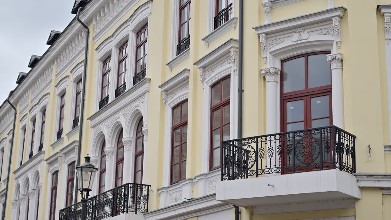 The facade of a yellow building in the Old Town of Bucharest, Romania