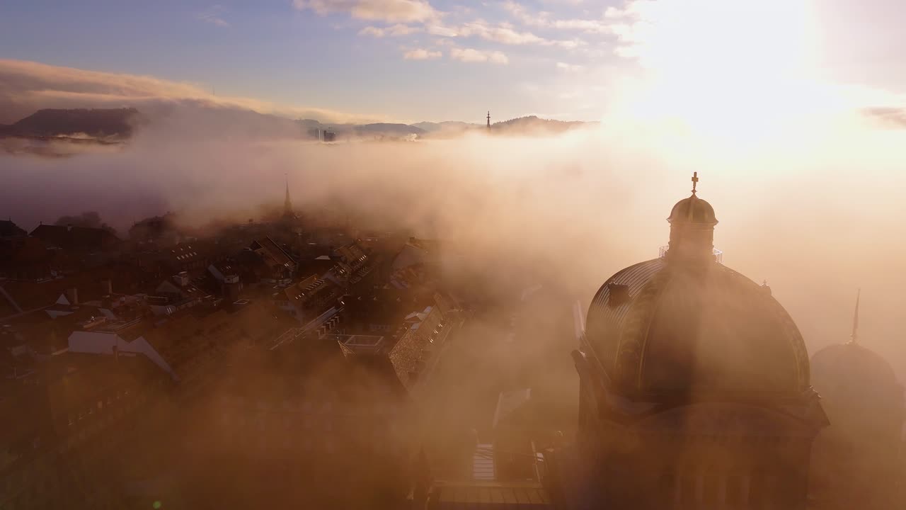 Bern capital city of Switzerland overflight during fog and sunrise