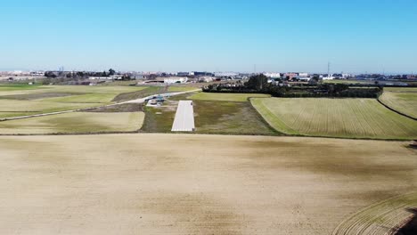 Small-runway-surrounded-by-grass-aerial-shot-like-airplane-point-of-view-landing