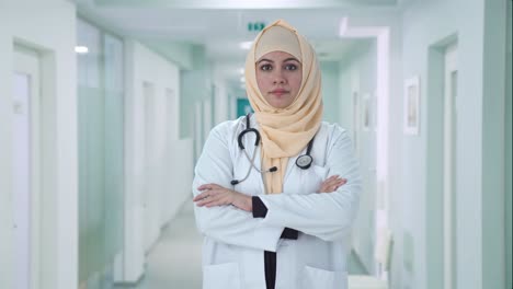 confident muslim doctor standing crossed hands