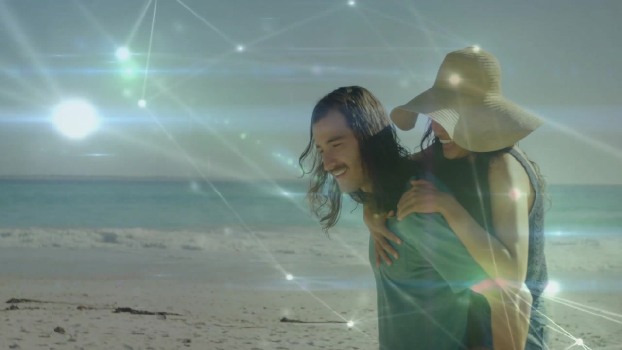 Couple strolling on sand initiating technology demo network graphics flickering, riding piggyback