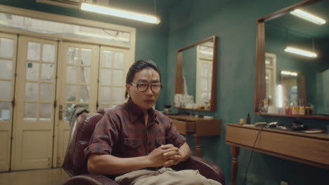 serious asian barber in the barbershop