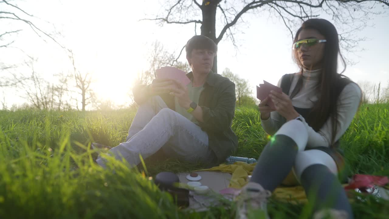 Couple Playing Cards Outdoors
