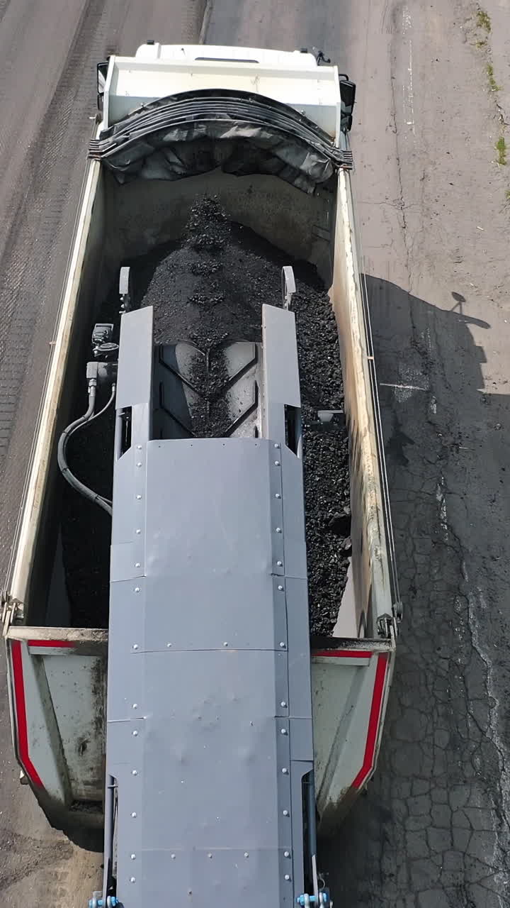 Construction and repair of highway. Aerial view of new highway construction site and equipment. Vertical video