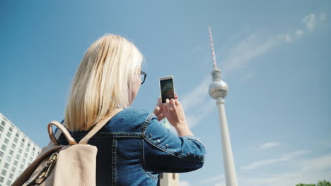 woman takes photos of berlin tv tower