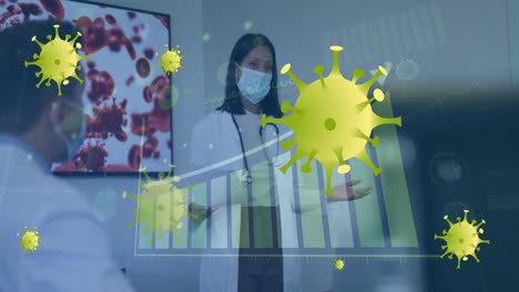 Animation-of-graph-and-virus-cells-over-diverse-doctors-wearing-face-masks