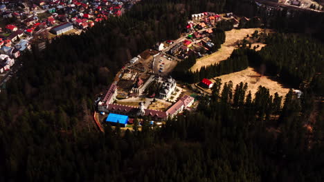 establishing shot of the caraiman monastery, top down view aerial drone, predeal