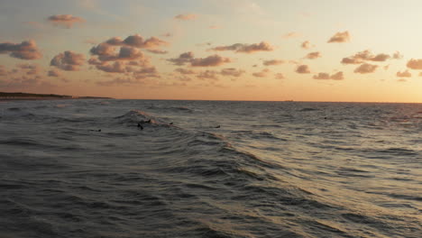 Surfers-in-front-of-the-touristic-town-Domburg-in-the-Netherlands-during-sunset