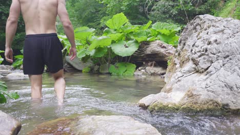 a man walking in a stream.