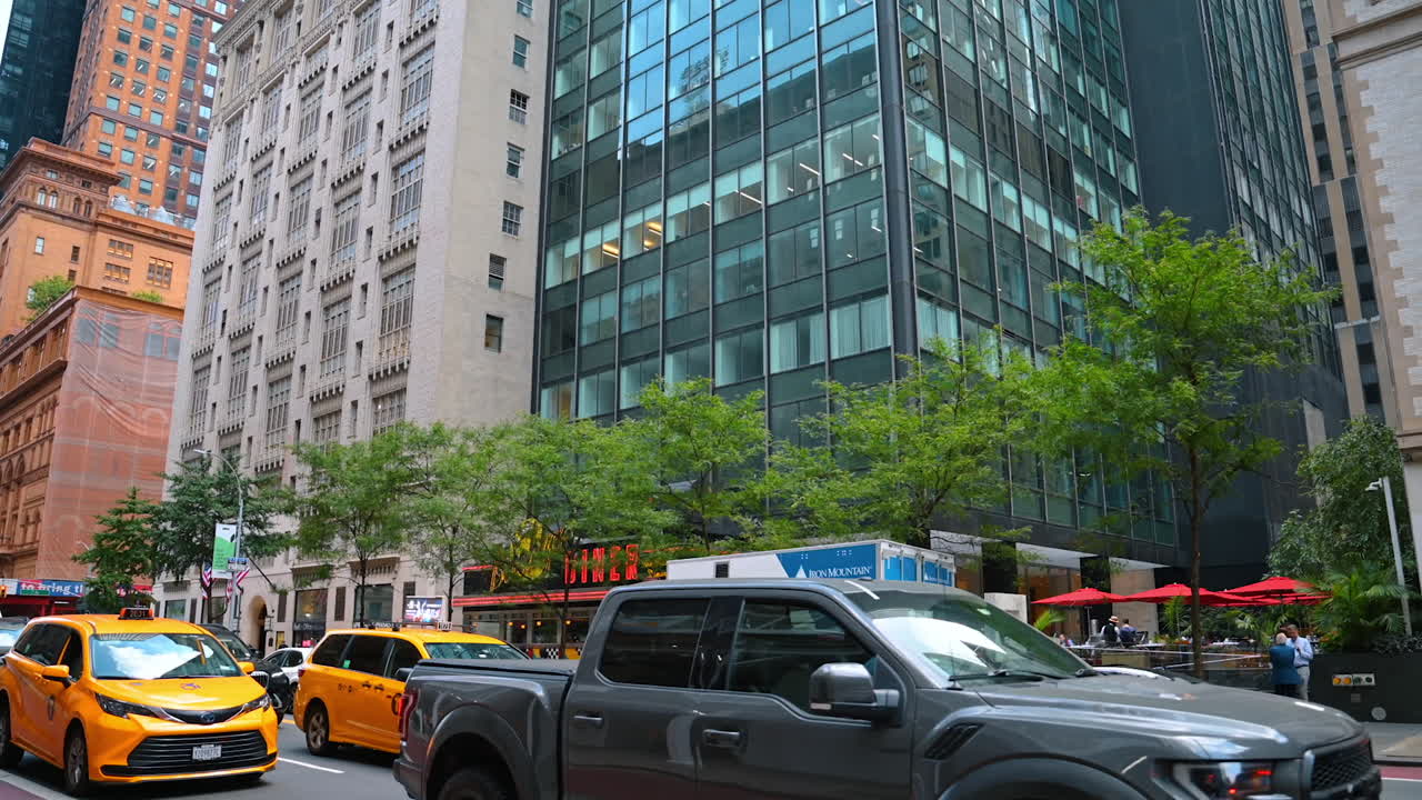 Busy Manhattan street with yellow taxis and traffic