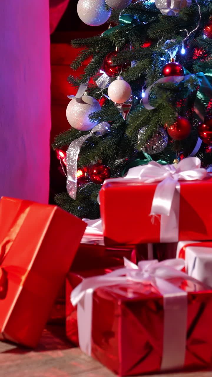 Many presents under Christmas tree. Beautiful Santa Claus toy near Christmas tree with gifts in the room. New Year eve. Vertical video