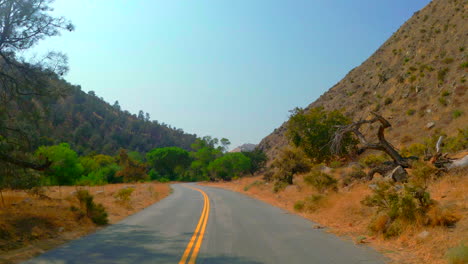 driving through a valley in the red mountains in the mojave desert of southern california