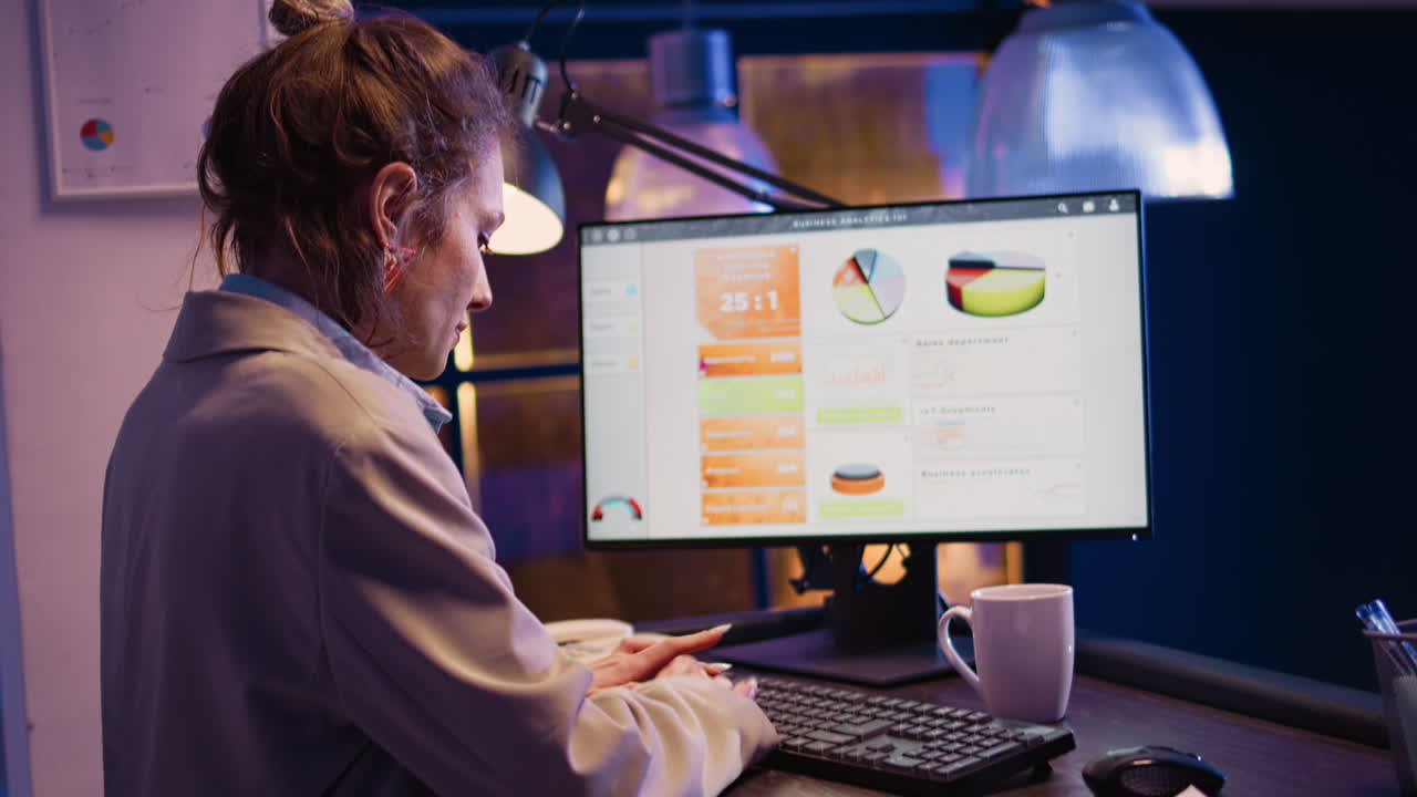 Woman working on business analytics on computer