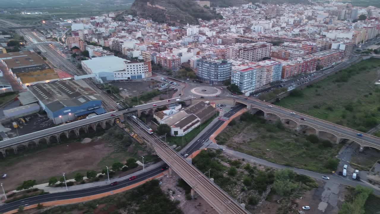 Aerial View of a City with Train Tracks and Bridges