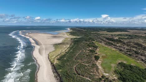 beautiful aerial drone shot flying over the dunes of burgh haamstede in the netherlands on a summer day