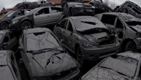 pile of damaged cars in a junkyard