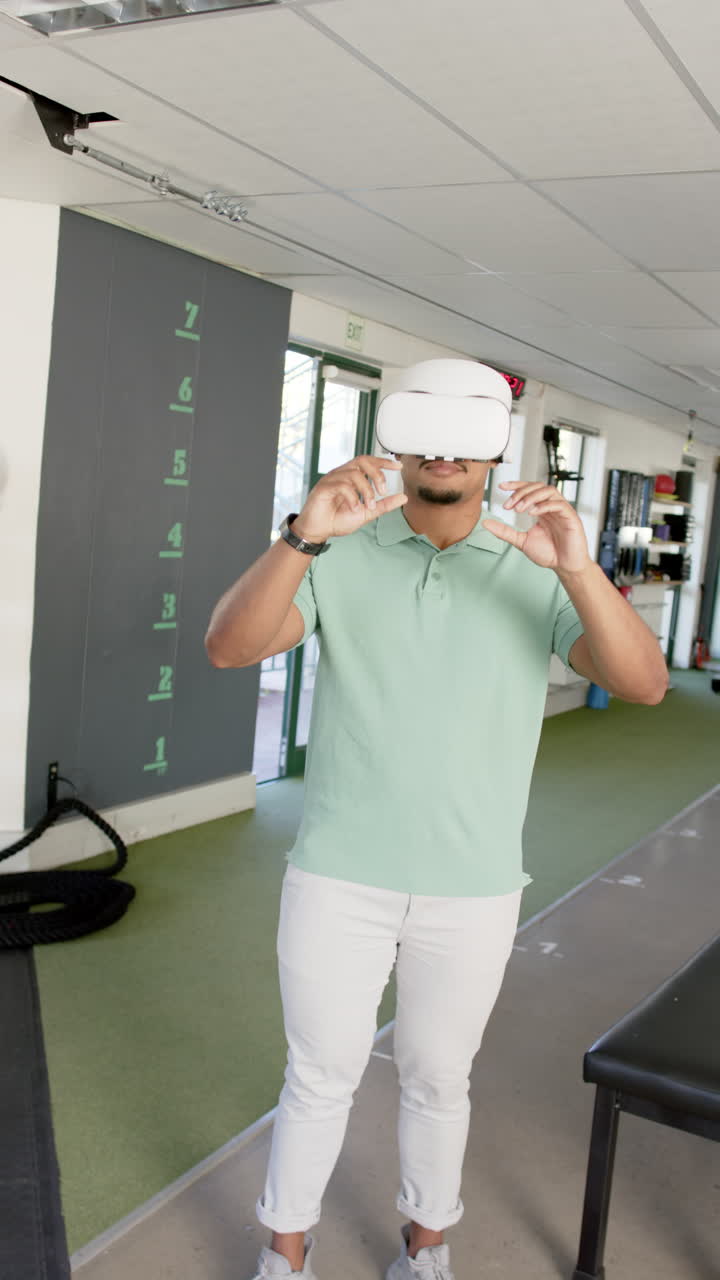 Vertical video: Man in rehabilitation center using VR vr headset for physical therapy exercises