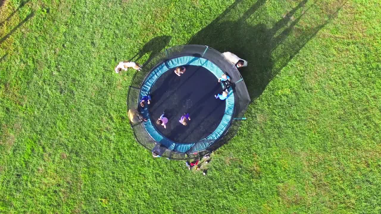 여름 동안 농장에서 휴가 여행 중에 트램폴린에 뛰어드는 아이들의 그룹