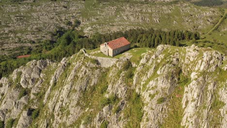 aerial drone view of the hermitage of santa eufemia on the top of a mountain in aulestia in the basque country