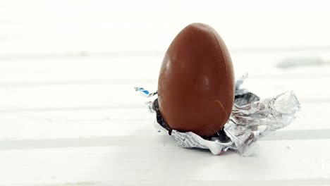 chocolate easter egg in foil on white background