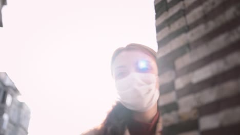 beautiful girl wearing protective medical mask and fashionable clothes looks at camera and be happy.new normal, corona,covid19 lifestyle concept.
